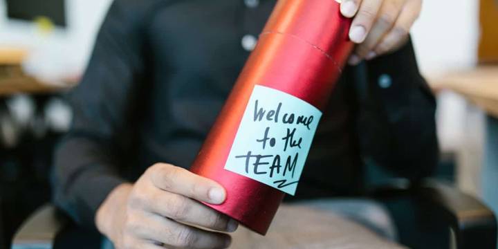 HR manager guiding a new hire through onboarding checklist